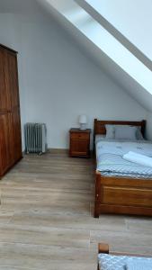 a bedroom with two beds and a wooden floor at Domek nad potokiem in Stronie Śląskie