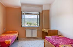 a bedroom with two beds and a window at Amazing Home In Spotorno With Wifi in Spotorno