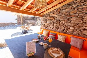 a patio with a table and a stone wall at Varandas de Monsaraz in Monsaraz