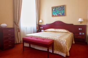 Postel nebo postele na pokoji v ubytování Aurora Premier Hotel