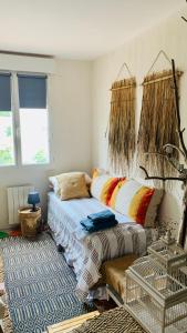 a bedroom with a bed and a rug at La Maison narbonnaise in Narbonne