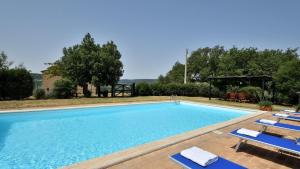a large swimming pool with lounge chairs next to it at Podere Firenzuola in Orvieto