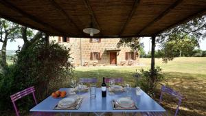 a blue table with a bottle of wine on it at Podere Firenzuola in Orvieto