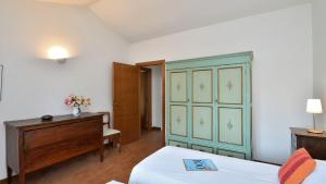 a bedroom with a bed and a dresser and a cabinet at Podere Firenzuola in Orvieto +23 photos