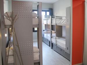 a room with three bunk beds with a lamp at BcnSportHostels in Barcelona +28 photos