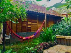a hammock in front of a house at Pousada Recanto Afetivo in Trindade