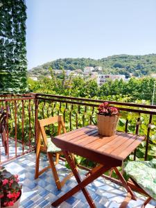 a wooden table on a balcony with a basket of flowers at Guesthouse DONA in Ulcinj +37 photos