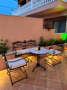 a patio with a table and chairs on a building at Kseynasa Suites in Nikiti