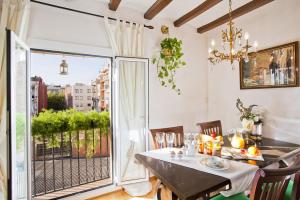 a dining room with a table and a large window at Apartment Eixample Comfort in Barcelona