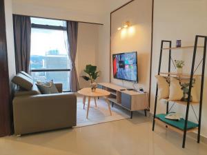 a living room with a couch and a table at KL Times Square Apartment in Kuala Lumpur