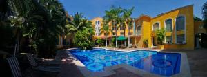 a house with a swimming pool in front of a house at Hotel Hacienda Real in Ciudad del Carmen