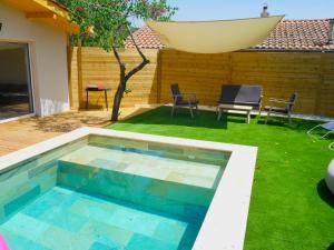 a swimming pool in the backyard of a house at Home le Vissou in Cabrières