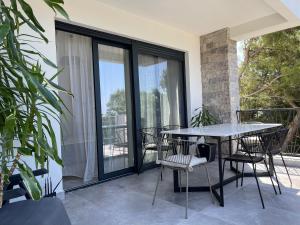 a patio with a table and chairs on a balcony at Villa Pine in Bar
