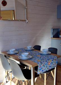 drewniany stół z krzesłami i ścierką stołową w obiekcie DOMKI WYPOCZYNKOWE ZOSIA I HELENKA w mieście Puck