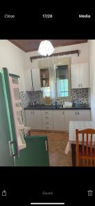 a kitchen with a table and a counter top at Villas Apartments SHAHAJ in Vlorë