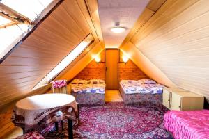 a attic room with beds and a table in it at Hotel Fran in Makov