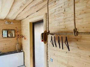 a kitchen with a wooden wall with knives on it at Sea Side Kaltene in Kaltene +34 photos