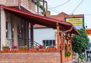 a group of potted plants on a brick building at Restoran & Motel Manjež in Bijelo Polje