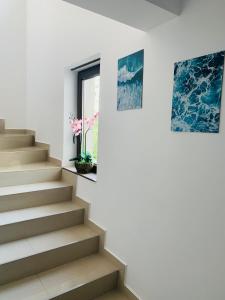 a staircase in a house with a vase of flowers at Vila Ardealul in Mangalia +34 photos