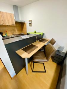 a kitchen with a wooden table and a sink at Apartment Dachstein nahe Zentrum in Bad Ischl