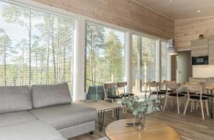 a living room with a couch and a table at Villa Paatari, Inari (Paadarjärvi) in Inari