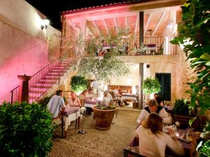 a group of people sitting at tables in a restaurant at Ca´n Pere in Alcudia