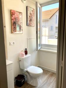 a bathroom with a white toilet and a window at La Casa, accès terrasse de l'établissement in Rives +38 photos