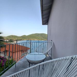 a balcony with a table and a view of the ocean at Ponti Bay Apartments in Vasiliki