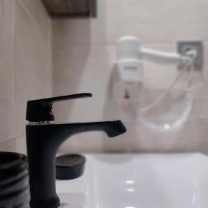 a kitchen sink with a black faucet on a counter at Ponti Bay Apartments in Vasiliki