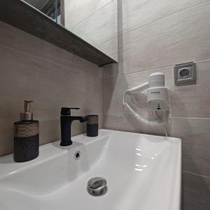 a bathroom with a sink with a faucet at Ponti Bay Apartments in Vasiliki