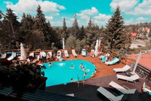 a group of people in a swimming pool at Alpin Resort Hotel - Apartamentele 2403-2404- proprietate administrata de gazda privata in Poiana Brasov
