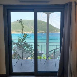 a view of the ocean from a room with a window at Ponti Bay Apartments in Vasiliki