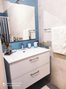 a bathroom with a white sink and a mirror at Ohana B&B in Marina di Camerota