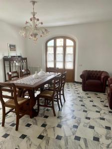 a dining room with a table and chairs at Villa Silvana in Querceta +21 photos