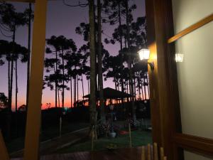 a view of a sunset from the window of a house at Pousada Villa Barril in Monte Verde +95 photos