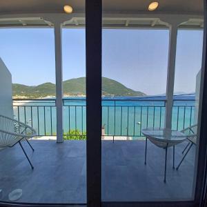 a view of the ocean from the balcony of a house at Ponti Bay Apartments in Vasiliki