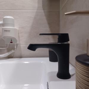 a black faucet on a sink in a bathroom at Ponti Bay Apartments in Vasiliki