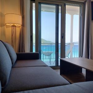 a living room with a couch and a view of the ocean at Ponti Bay Apartments in Vasiliki