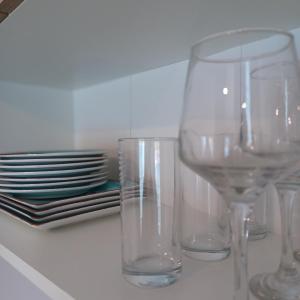 a group of glasses sitting on a counter with plates at Ponti Bay Apartments in Vasiliki