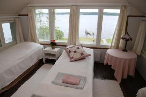 a bedroom with a bed and a large window at Villa Haapaniemi in Iisalmi