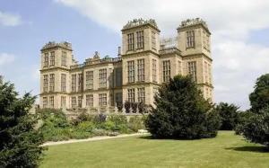 a large castle with a grass field in front of it at Peaceful Cabin in Skegby -Sleeps2- Firer Pit in Sutton in Ashfield