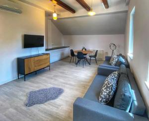 a living room with a couch and a tv and a table at "Dolina" na Żuławach in Nowe Dolno