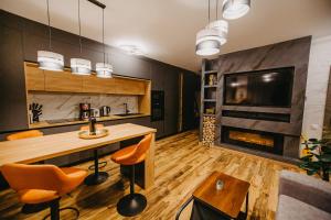 a kitchen with a fireplace and a table and chairs at Ap.Casa la Neamtu in Sibiu