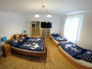 a bedroom with two beds and a flat screen tv at Step88 in Balatonlelle