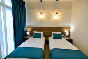 Postel nebo postele na pokoji v ubytování Hill Hotel