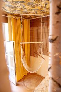 a hammock hanging from a ceiling in a room at Sishaus Hostel in Graz