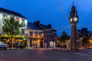a clock tower in the middle of a town at night at 1997 Stays Westport in Westport