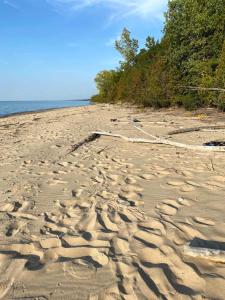 a sandy beach with ripples in the sand at All the Waters Retro Home on Lake Michigan- Your Own PRIVATE BEACH in Benton Harbor