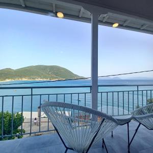a balcony with a table and chairs and the ocean at Ponti Bay Apartments in Vasiliki