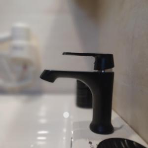a black faucet sitting on top of a sink at Ponti Bay Apartments in Vasiliki